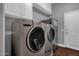 Convenient laundry room with washer, dryer, and ample cabinet storage at 1570 W Bartlett Way, Chandler, AZ 85248