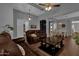 Spacious living room with leather sofas and a built-in bookshelf at 1570 W Bartlett Way, Chandler, AZ 85248