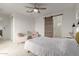 Bedroom with sliding barn door, two armchairs, and a ceiling fan at 1685 S Wallrade Ln, Gilbert, AZ 85295