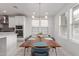 Bright dining area with wood table and chairs, an island, and modern light fixture at 1685 S Wallrade Ln, Gilbert, AZ 85295