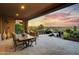 Covered patio boasts stunning sunset views and outdoor furniture at 17676 E Woolsey Way, Rio Verde, AZ 85263