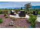 Relaxing patio area with fire pit and desert landscaping at 17676 E Woolsey Way, Rio Verde, AZ 85263