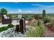 Water feature and seating area on a stone patio with desert views at 17676 E Woolsey Way, Rio Verde, AZ 85263