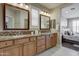 Double vanity bathroom with granite countertops and view of bedroom at 17676 E Woolsey Way, Rio Verde, AZ 85263