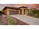 Single-story home with stone accents and a two-car garage at 17676 E Woolsey Way, Rio Verde, AZ 85263