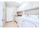 Laundry room with washer, dryer and cabinets at 1872 E Shannon St, Chandler, AZ 85225