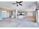 Open concept living room and kitchen with a ceiling fan and carpeting at 1872 E Shannon St, Chandler, AZ 85225