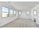 Bright bedroom with carpet, multiple windows providing views and natural light at 18950 W Stella Ave, Waddell, AZ 85355