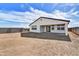 Back of home showing the covered patio, fenced yard, and modern architectural style at 18950 W Stella Ave, Waddell, AZ 85355