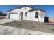 New construction home with a two-car garage and desert landscaping at 18950 W Stella Ave, Waddell, AZ 85355