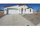 Modern curb appeal with a two-car garage and gravel driveway at 18950 W Stella Ave, Waddell, AZ 85355