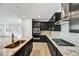 Modern kitchen with stainless steel appliances, granite countertops, and dark cabinetry at 18950 W Stella Ave, Waddell, AZ 85355