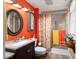 Bathroom with orange walls, granite vanity, and shower/tub combo at 19019 N Camino Del Sol --, Sun City West, AZ 85375