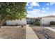 Front view of a single-story home with a walkway, landscaping, and rock garden at 19019 N Camino Del Sol --, Sun City West, AZ 85375