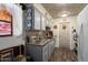 Gray cabinets, granite counters, and a charming farmhouse door accent this kitchen at 19019 N Camino Del Sol --, Sun City West, AZ 85375