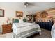 Main bedroom with wood-look floors, a wood-paneled accent wall, and ample closet space at 19019 N Camino Del Sol --, Sun City West, AZ 85375