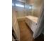 Clean bathroom with double vanity, tub, and wood-look tile floor at 19026 W Stella Ave, Waddell, AZ 85355