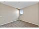 Simple bedroom featuring neutral walls, carpeted floors, and a window at 19026 W Stella Ave, Waddell, AZ 85355