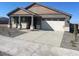 New construction home with neutral color scheme and a driveway at 19026 W Stella Ave, Waddell, AZ 85355