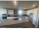 Spacious kitchen with an island, white cabinets, and granite countertops at 19026 W Stella Ave, Waddell, AZ 85355