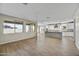 Open-concept living area with wood-look flooring, bright windows, and seamless kitchen access at 19026 W Stella Ave, Waddell, AZ 85355