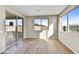 Bright living room featuring wood-look tile floors, neutral walls and a large sliding glass door at 19026 W Stella Ave, Waddell, AZ 85355