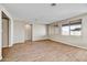 Spacious living room with wood-look flooring, recessed niche, and abundant natural light at 19026 W Stella Ave, Waddell, AZ 85355