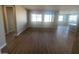 Spacious living room featuring hardwood floors and access to kitchen at 19026 W Stella Ave, Waddell, AZ 85355