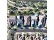 Birds-eye view of a residential neighborhood featuring diverse roofing styles and green backyard landscaping at 20363 W Coolidge St, Buckeye, AZ 85396