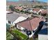 Aerial view of a landscaped backyard with artificial turf, covered patio and outdoor dining. Mountains in the background at 20363 W Coolidge St, Buckeye, AZ 85396