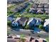 Aerial view of a well-maintained neighborhood featuring houses with brown roofs and green landscaping at 20363 W Coolidge St, Buckeye, AZ 85396