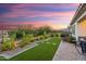 Beautiful backyard featuring artificial turf, rock beds, and a wrought iron fence with mountain views at 20363 W Coolidge St, Buckeye, AZ 85396