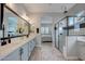 Elegant bathroom with double sinks, a large mirror, and a glass shower at 20363 W Coolidge St, Buckeye, AZ 85396