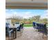 Covered patio with outdoor dining and seating area, overlooking a landscaped backyard at 20363 W Coolidge St, Buckeye, AZ 85396