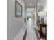 View down long entry hall showcasing tile floor and access to living room at 20363 W Coolidge St, Buckeye, AZ 85396