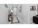 Bright entry hall with wood-look tile floor, console table, and art at 20363 W Coolidge St, Buckeye, AZ 85396