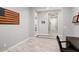 Hallway showcases plank flooring with tiled insets and views into adjacent rooms, enhancing the open feel of the home at 20363 W Coolidge St, Buckeye, AZ 85396