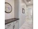 Hallway features built-in cabinetry with a tiled countertop and a view down the hall to a bright doorway at 20363 W Coolidge St, Buckeye, AZ 85396