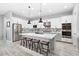 Modern kitchen with white cabinets, a large island, and stainless steel appliances at 20363 W Coolidge St, Buckeye, AZ 85396