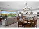 Open floor plan with seamless transitions between the kitchen, living room, dining area, and outdoor patio at 20363 W Coolidge St, Buckeye, AZ 85396