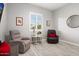 Comfortable living room showcasing wood floors, plantation shutters, and two inviting armchairs at 20363 W Coolidge St, Buckeye, AZ 85396