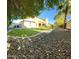 Landscaped backyard with grassy area and mature trees at 21525 E Camacho Rd, Queen Creek, AZ 85142