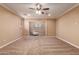 Spacious bedroom with ceiling fan and plush carpeting at 21525 E Camacho Rd, Queen Creek, AZ 85142