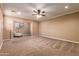 Large bedroom with ceiling fan and plush carpeting at 21525 E Camacho Rd, Queen Creek, AZ 85142