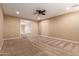 Bright bedroom with ceiling fan and carpeting at 21525 E Camacho Rd, Queen Creek, AZ 85142