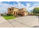 Two-story house with tan exterior, landscaping, and a driveway at 21525 E Camacho Rd, Queen Creek, AZ 85142