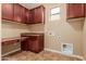 Laundry room with built-in cabinets and workspace at 21525 E Camacho Rd, Queen Creek, AZ 85142