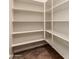 Spacious pantry with ample shelving for storage at 21525 E Camacho Rd, Queen Creek, AZ 85142