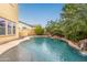 Refreshing pool with a waterfall feature and plenty of space for relaxation at 21525 E Camacho Rd, Queen Creek, AZ 85142