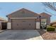 Two-car garage and front entry of a single story home at 2185 E Hazeltine Way, Gilbert, AZ 85298